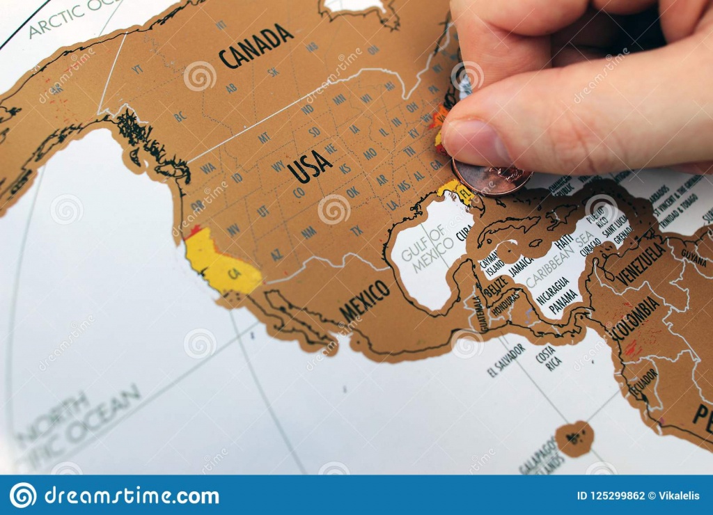 Man`s Hand Scratching Off Visited Places On A Map. Stock Photo - Florida Scratch Off Map